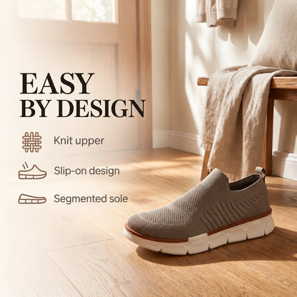 Taupe XE5813 knit slip-on shoe in an entryway, with labels for the knit upper, slip-on design and segmented sole.