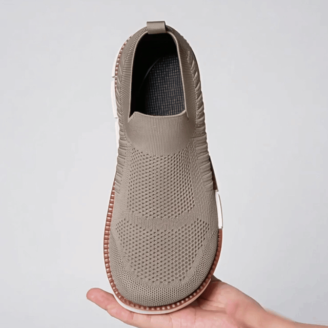 Knit slip-on sneaker stretching across a wide forefoot