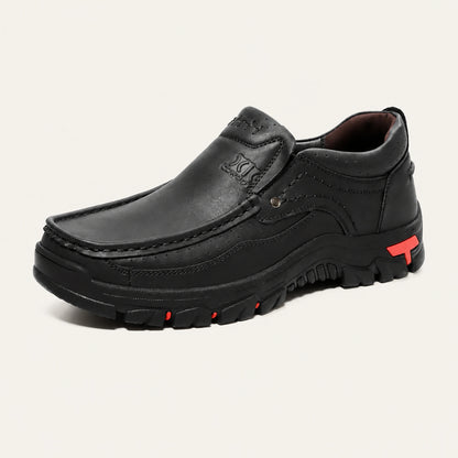 Black XK8815 slip-on shoe with a padded collar and red outsole accents.
