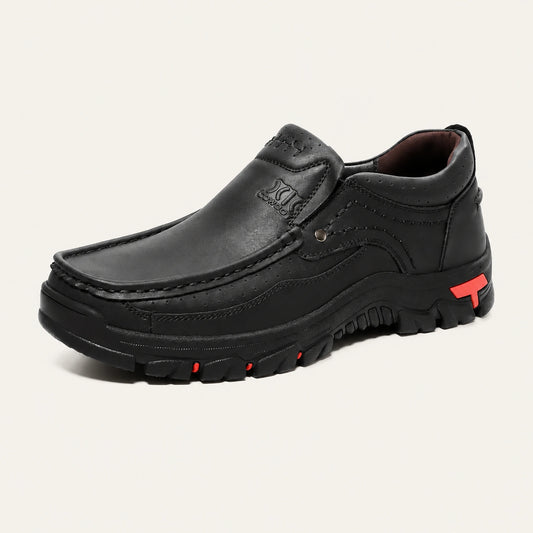 Black XK8815 slip-on shoe with a padded collar and red outsole accents.