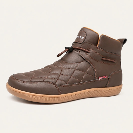 Dark brown 95856 quilted slip-on ankle boot with a gum-colored sole on a warm off-white background.