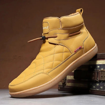 Tan 95856 quilted ankle boot displayed beside a vintage storage case.