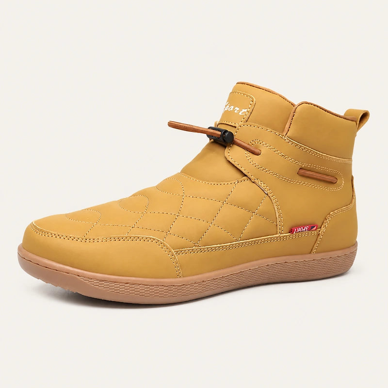 Tan 95856 quilted slip-on ankle boot with an adjustable elastic toggle on a warm off-white background.